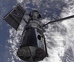 Hubble Space Telescope being held by the space shuttle Atlantis (credit: NASA)