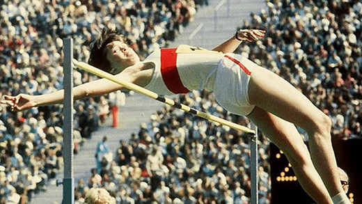 Germany's divided status was symbolized by the different uniforms that track-and-field athletes wore in international competitions: all white with a red chest stripe for West Germany; dark blue top and white shorts for East Germany. The photo shows Ulrike Meyfarth, who won the women's high jump at the 1972 Munich Olympics.