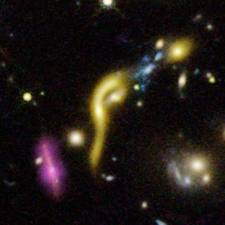 A collection of galaxies, one showing an extremely curved shape