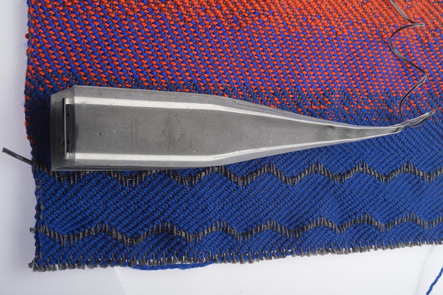 A blue and red fabric with a wire connected to a sensor
