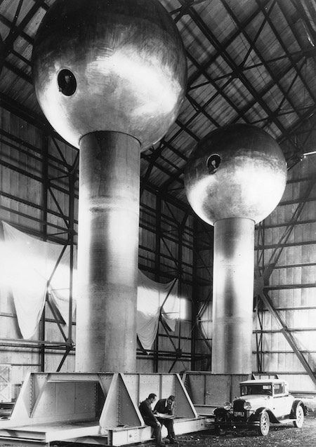 John Trump helped redesign these 12-meter-high Van de Graaff generators, seen here in an airship hangar at Round Hill, Massachusetts. The generators are now at Boston’s Museum of Science. Credit: AIP Emilio Segrè Visual Archives