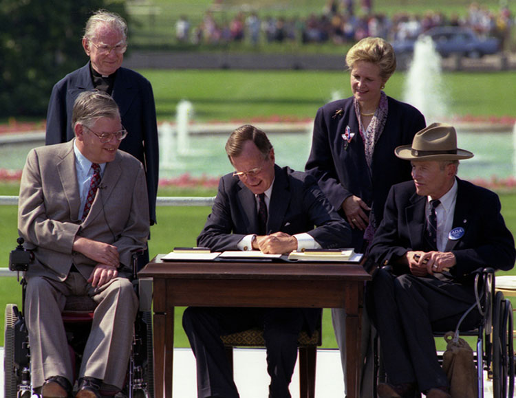 President Bush signs the Americans with Disabilities Act on 26 July 1990.