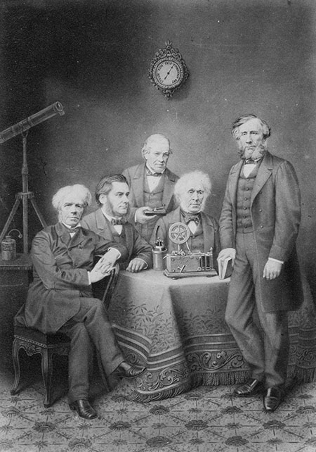 Michael Faraday, Thomas Huxley, Charles Wheatstone, David Brewster, and John Tyndall in a photograph.