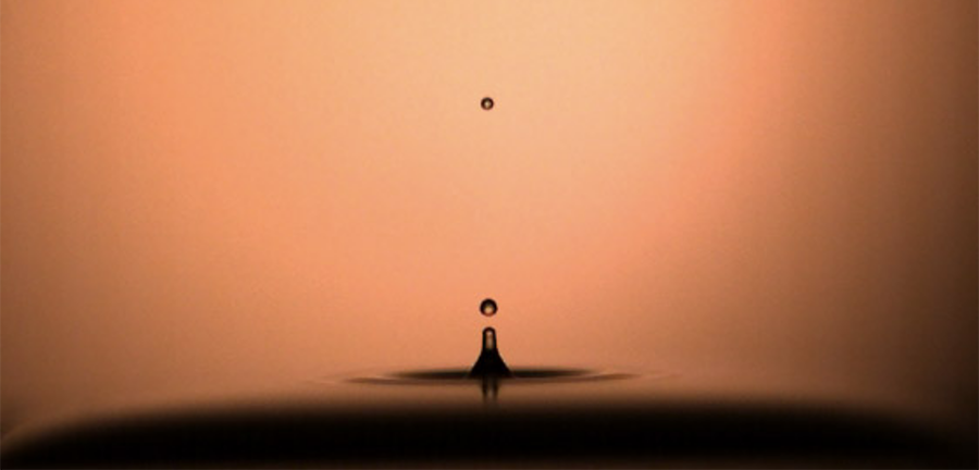 A rebounding droplet of water showing two spheres of water above the surface.