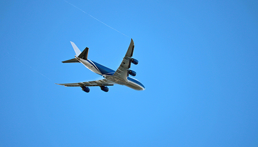 An airplane flies on a clear day.