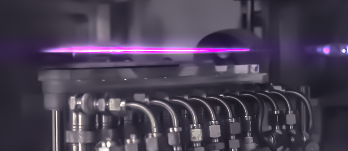 A purple beam above machinery.