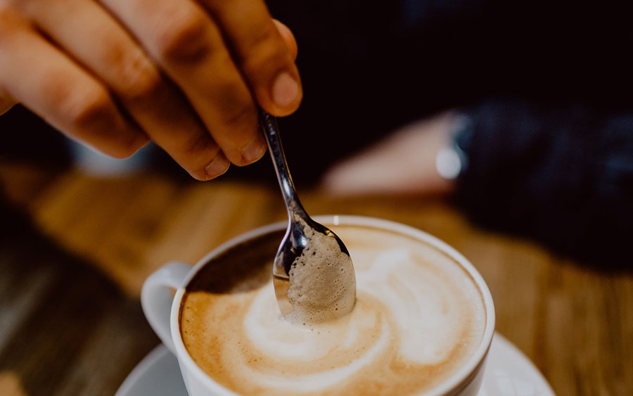 Stirring a mug of hot chocolate.