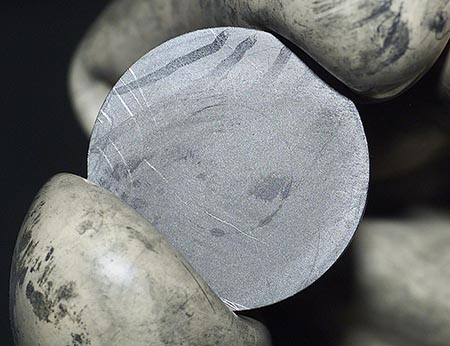 A small disk of plutonium metal. Credit: LANL