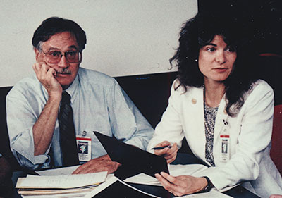 Brad Smith and Carolyn Porco (author) in a meeting at JPL during the Voyager Neptune encounter, August 1989, discussing images to be presented at the daily press briefing the following morning. Photo Credit: Courtesy Carolyn Porco