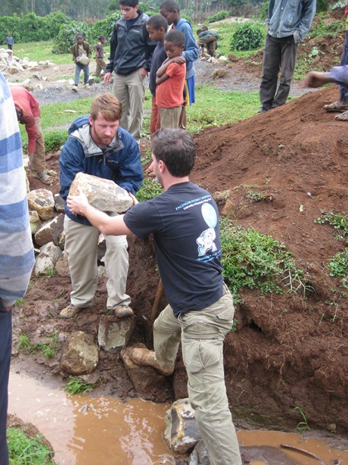EWB team members Brett Jensen and Ed Elder assess the water outfall of the storm drainage system built in January 2013. The EWB team and the town had to work together to bring this system to its optimum operating potential. CREDIT: Catherine O'Riordan