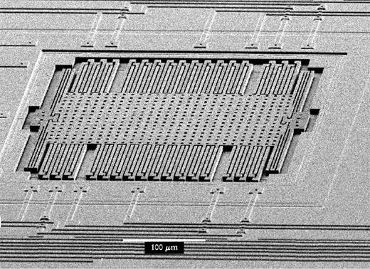  . Figure 1. A MEMS accelerometer is a key component of many automobile airbag sensors. The device consists of a center region, the proof mass, which is connected by springs to the surrounding structure. The interdigitated fingers are capacitors used by on-chip electronics (not shown) to sense acceleration. 