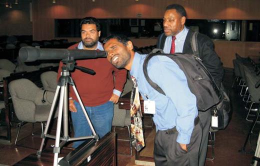  . At the launch of the International Year of Astronomy, Brazil’s Kepler de Oliveira (left), South Africa’s Kevin Govender (looking through telescope), and Derrick Pitts of the Franklin Institute in Philadelphia check out a prototype of a telescope that is now for sale under the IYA cornerstone project Galileoscope. The launch took place in January at the United Nations Educational, Scientific and Cultural Organization headquarters in Paris. 