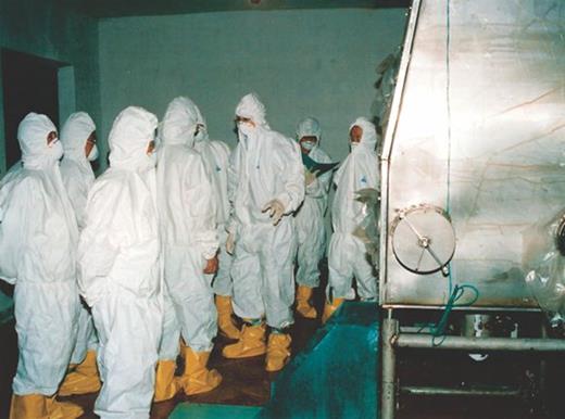 Figure 5. The Yongbyon nuclear complex during my August 2007 visit to North Korea. Unlike during my first visit in 2004, my hosts allowed me to see the plutonium laboratory. It would not have passed safety protocol at Los Alamos National Laboratory. Although I had reservations about venturing into the lab, whose electricity had just been turned back on after a power outage, I entered suited up (third from right). The tour was most informative, and I was able to make a good assessment of their plutonium capabilities and capacities. That visit convinced me that Pyongyang was prepared to shut down plutonium operations at Yongbyon. They now still appear to be, although my November 2010 visit suggested an alternate route to the bomb: uranium enrichment.
