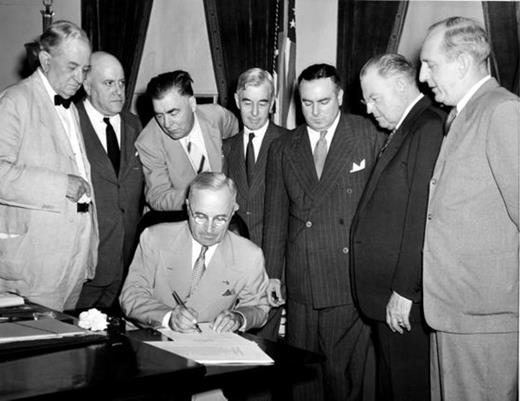 . Flanked by seven US senators, President Harry S. Truman signs the Atomic Energy Act of 1946. One of the act's provisions empowered the Atomic Energy Commission to regulate "restricted data," a new and sweeping category (Courtesy of the US Department of Energy.)