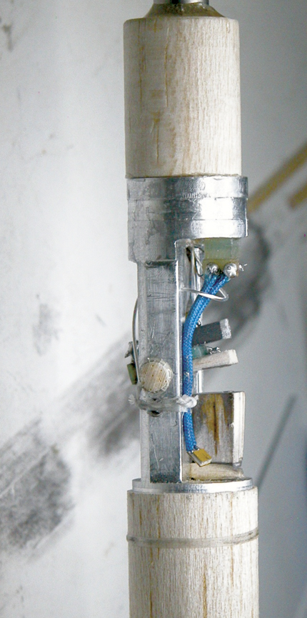 . Figure 2. The apparatus for resonant ultrasound spectroscopy1 contains two transducers 1.5 mm in diameter, which weakly couple to a crystal to probe its vibrational resonances. Balsa wood provides vibrational isolation over a broad temperature range.