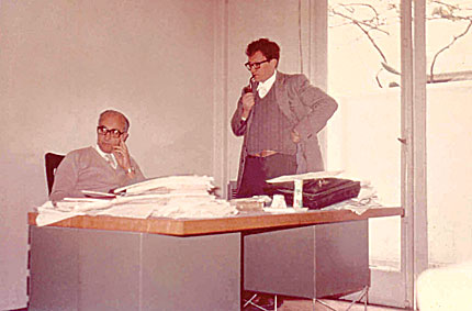 Figure 1. Working together in a makeshift office in Buenos Aires are Carlos Guido Bollini (seated) and Juan José Giambiagi. The photo was taken in the early 1970s. (Courtesy of Marcia Giambiagi.)