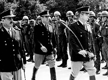 Figure 4. General Luciano Menéndez (right) inspects the troops of Operation Independence in Tucumán, Argentina, in 1975. Menéndez helped lead the coup d’état that ousted Isabel Perón in March 1976. By the end of 1997, physicists Juan José Giambiagi and Carlos Guido Bollini exiled themselves from their homeland.