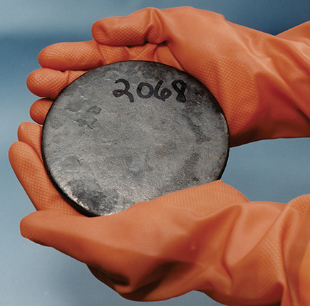 . A “button” of highly enriched uranium metal. HEU comes in various forms, including oxides, solutions, and new or irradiated reactor fuel. All HEU is considered weapons usable.