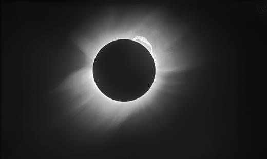 . The 1919 solar eclipse provided the first experimental evidence of the theory of general relativity. Using glass photographic plates, Arthur Eddington and Andrew Crommelin imaged the eclipse, as shown here after restoration and modern processing. When stars were close to the Sun—and visible during the eclipse—they appeared displaced due to the bending of light by the Sun’s gravity, as predicted in general relativity. The observation created demand for popular science books explaining the topic. (Courtesy of ESO/ Landessternwarte Heidelberg-Königstuhl/F. W. Dyson, A. S. Eddington, and C. Davidson.)
