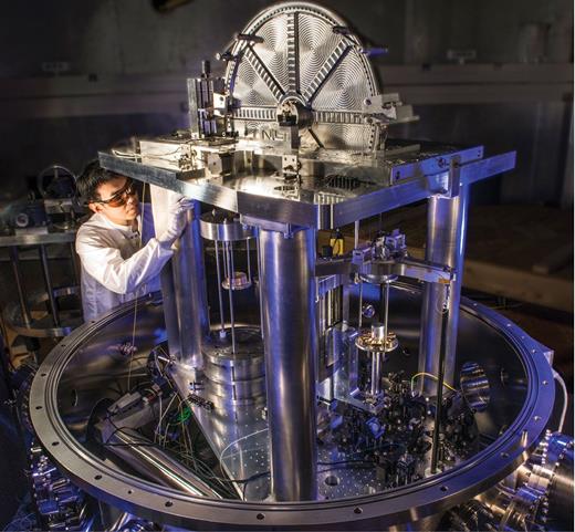 Figure 4. The NIST-4 Kibble balance, being adjusted by Leon Chao. (Courtesy of Curt Suplee/NIST.) 