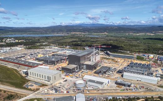  . Aerial view of the ITER site in May 2021. The cryoplant, magnet power conversion facility, and electrical switchyard are located to the left of the tokamak complex and assembly hall at center. The heat-rejection plant and central offices are to the right. 