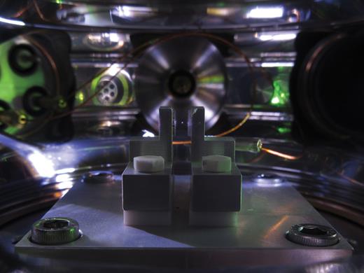 A small silica sphere hovers nearly motionless in a vacuum chamber. Credit: Yale Wright Lab
