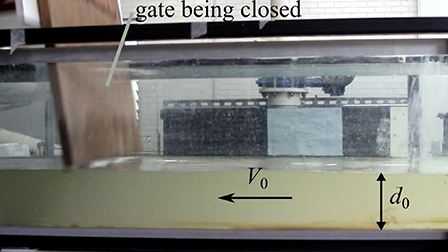 Hydrodynamic shock in Rivers: Physical and numerical modeling of flow